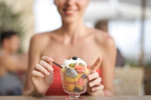 woman holding spoon eating healthy snack