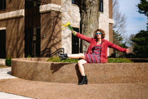 woman wearing red jacket sitting on platform